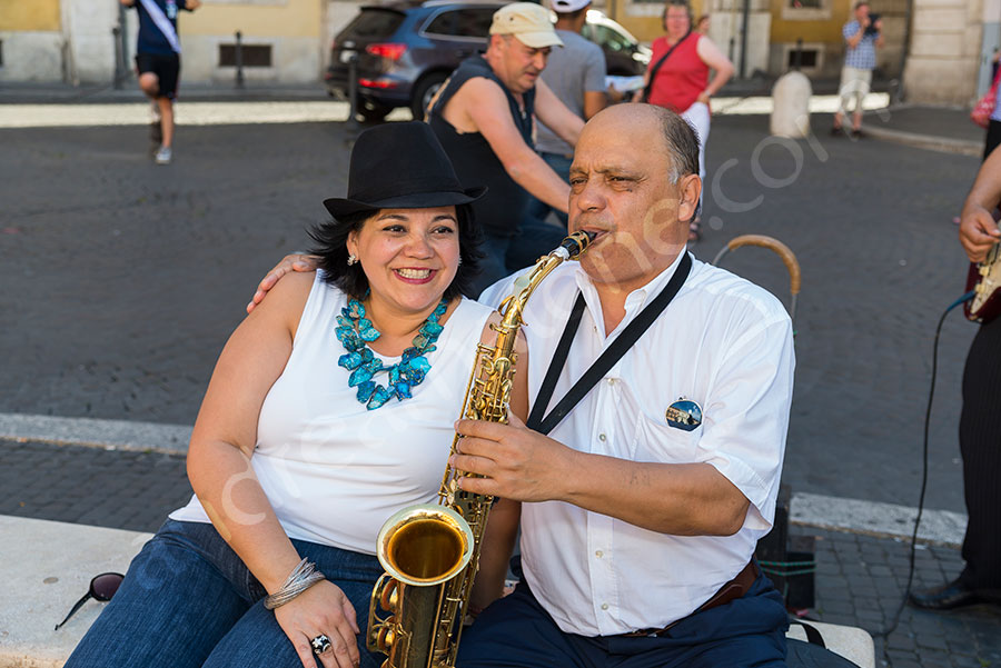 Portrait picture of a woman with a street musician in Rome Italy