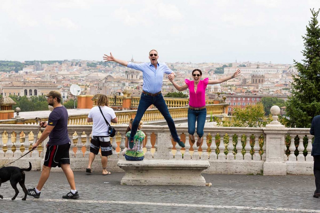 Jumping in the air at Gianicolo over the view of Rome during a photo tour