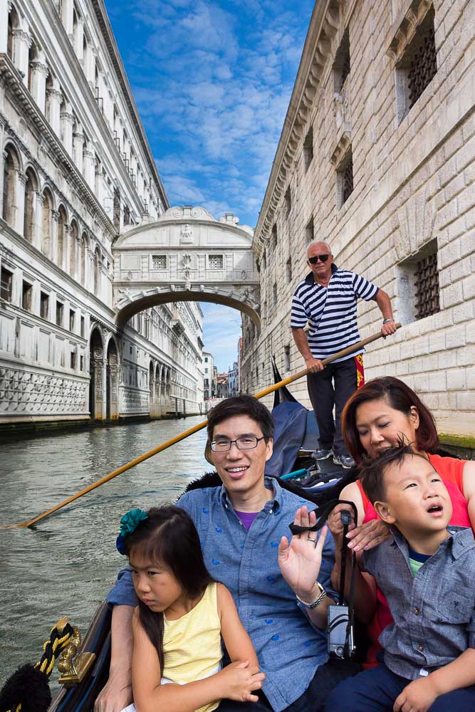 Venice Photo Tours. Riding on a gondola boat through the canals. Italy.