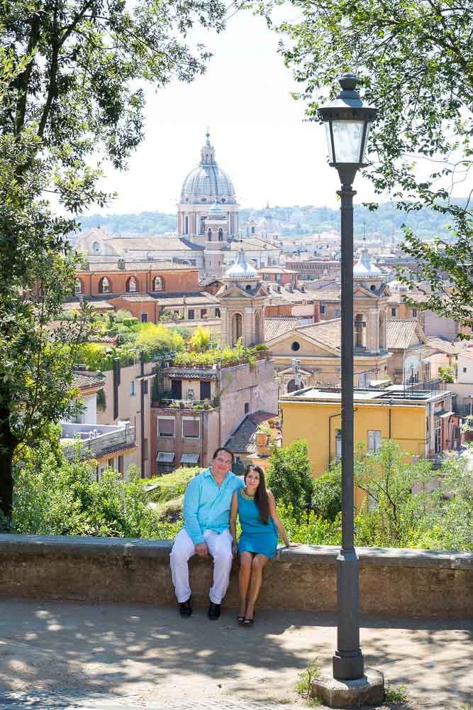 Couple sitting down during a photo session in the city of Rome Italy