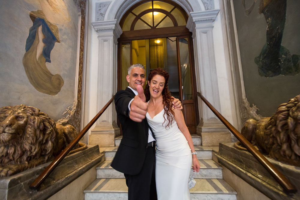 Bride and groom exiting the apartment building after the preparations. Planning a wedding in Rome.