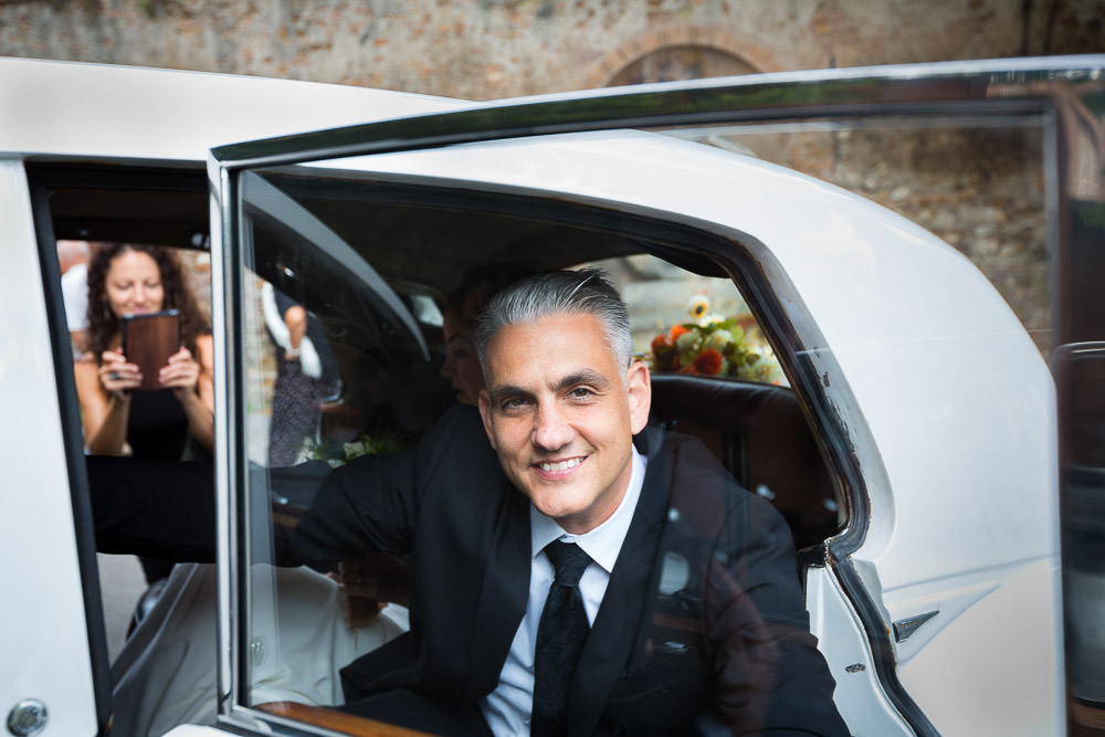 The groom exiting the car to reach the marriage location.