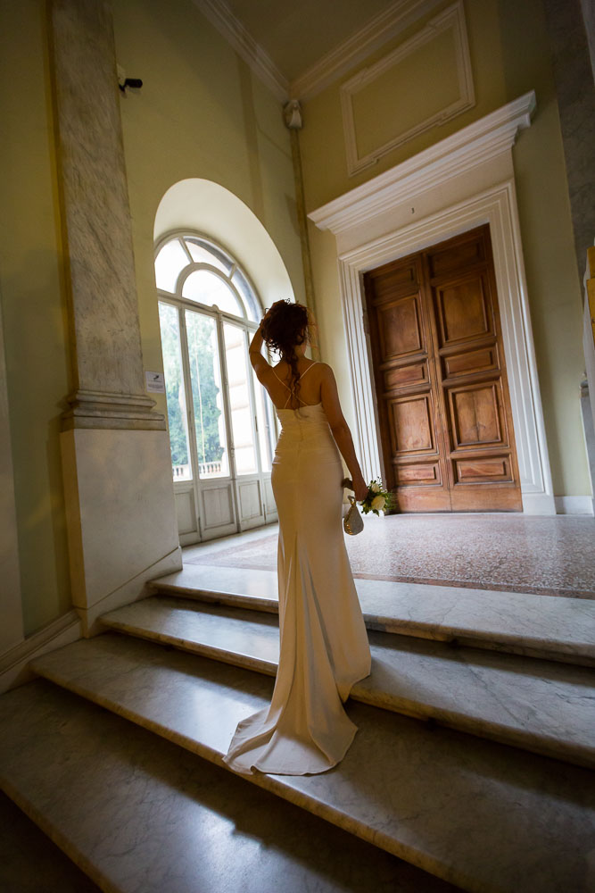 Bridal portrait. Picture taken from behind with the dress on the stairs.