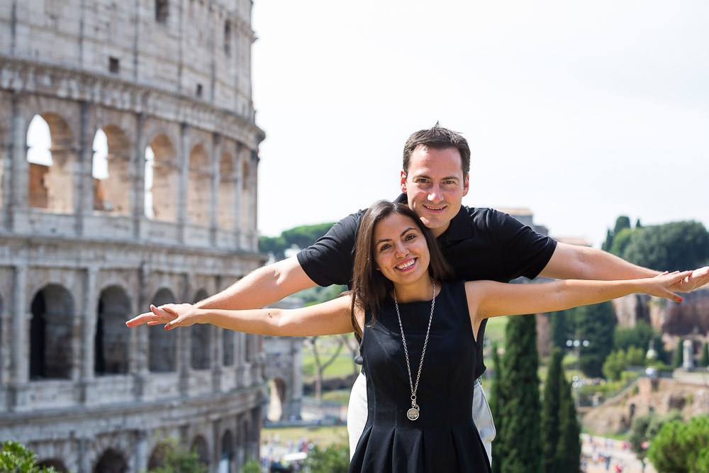 Arms out stretched in front of the Coliseum