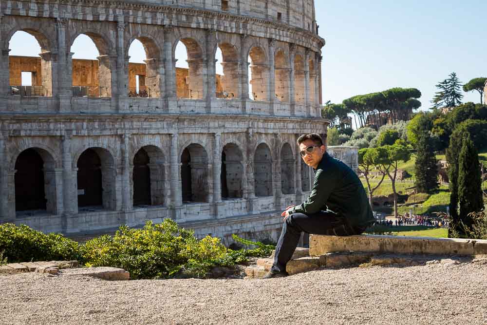 Person sitting down before the Colosseum