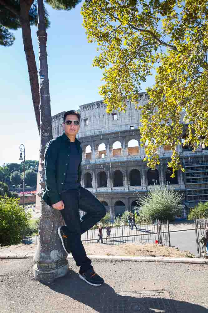 Leaning on a light pole by the Roman Colosseum