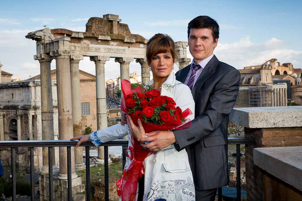 Portrait picture of an engaged couple in front of the Roman Forum.