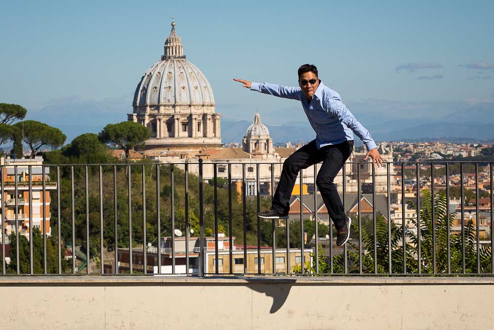 Jumping up in the air with Saint Peter's cathedral in the background during photography tours rome italy.
