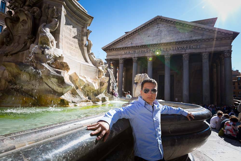 Standing in front of the roman pantheon by the water fountain.