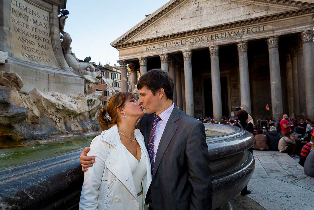 Kissing next a water fountain.