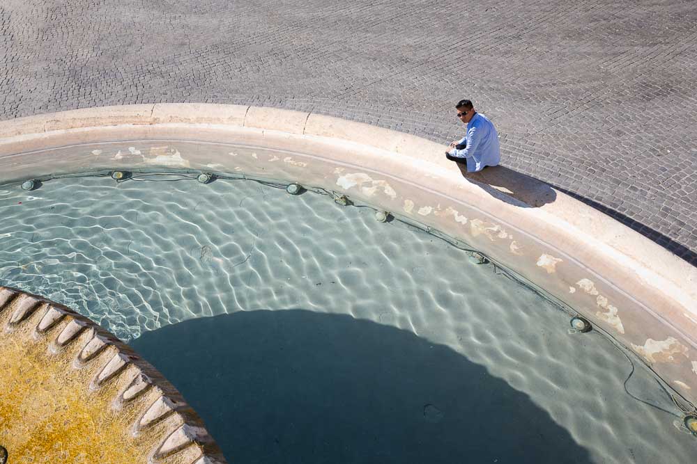 Sitting down by the water fountain found at the bottom of Piazza del Popolo