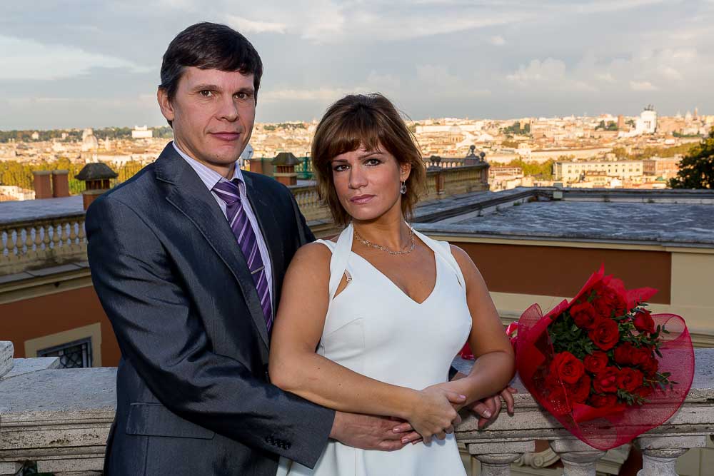 Engaged couple picture over the roman rooftops.