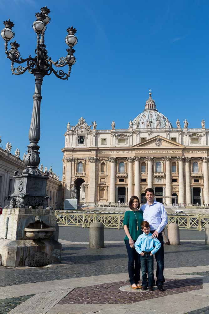 Family standing together before Saint Peter's Cathedral in the Vatican