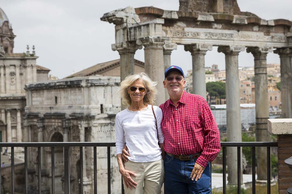 Couple visiting the roman forum smiling for the camera