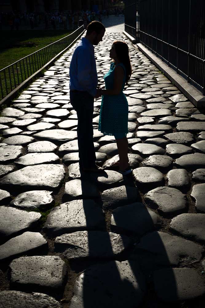 Couple silhouette image standing on an ancient roman road 