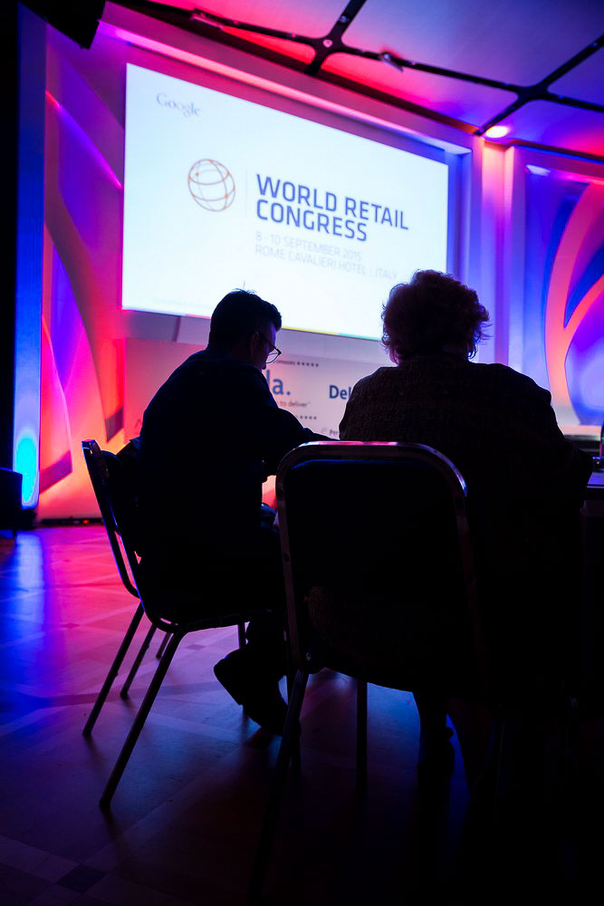 Convention attendee looking at the screen during the awards presentation. International Congress Photography in Rome