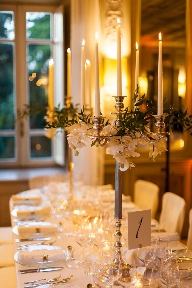 Dinner table setting lit by candle light