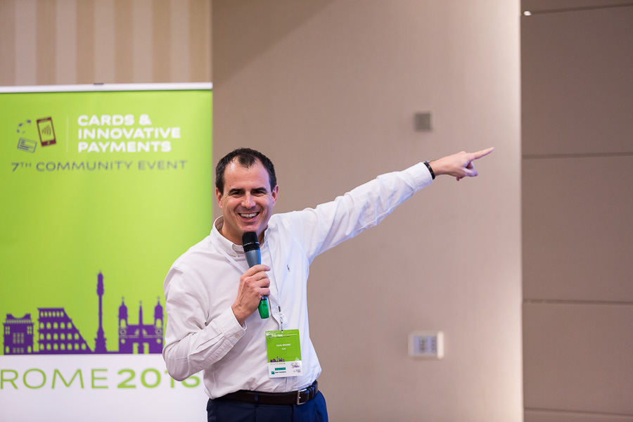 Man pointing to the screen while talking to a conference audience