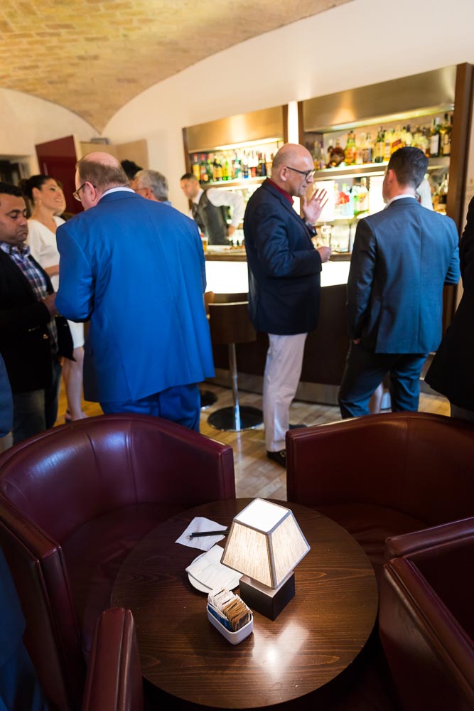 Guests talking by the bar