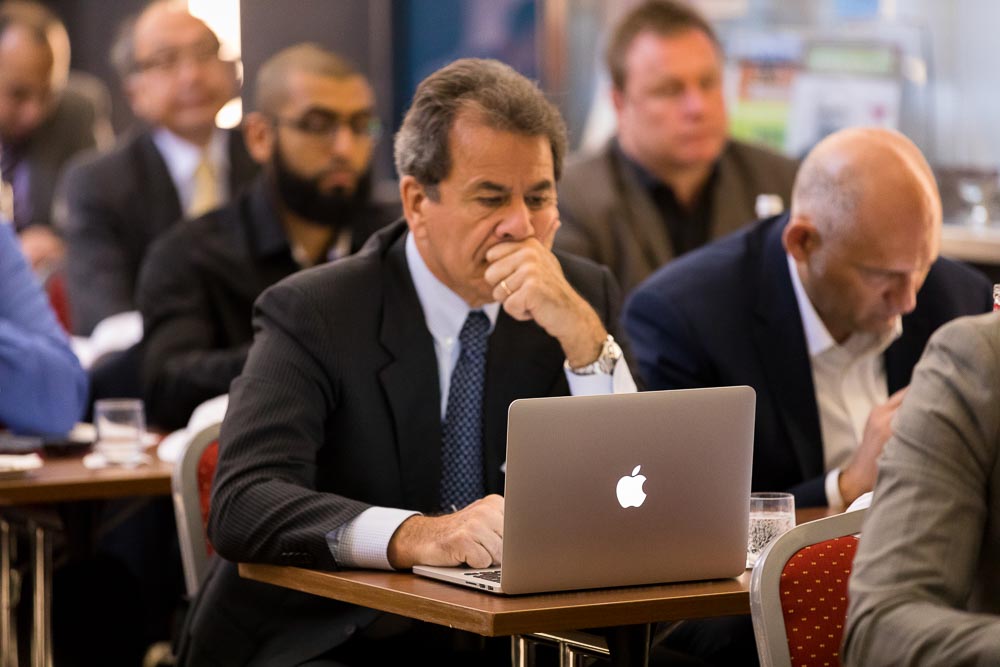 Participants taking notes and listening