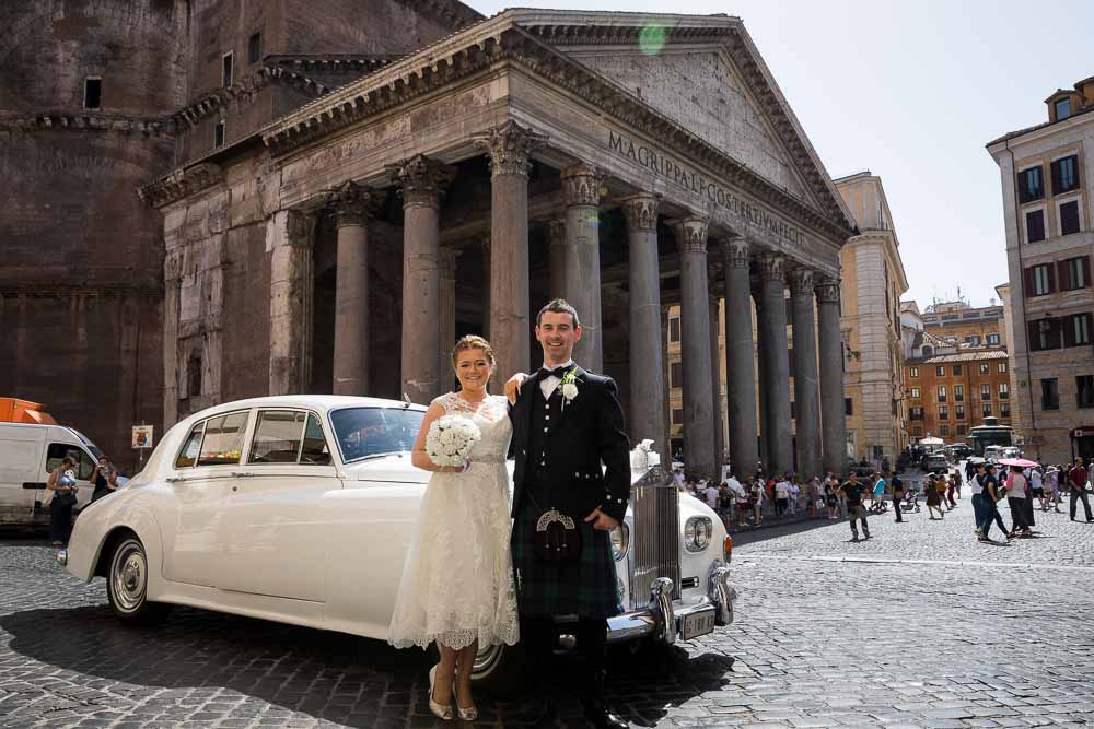 Poising in front of the vintage wedding car before getting married