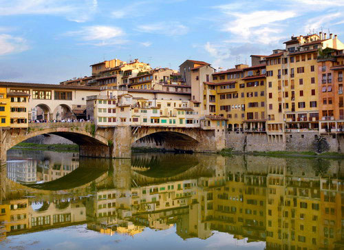 Image view of the Ponte Vecchio bridge water reflection over the Arno river